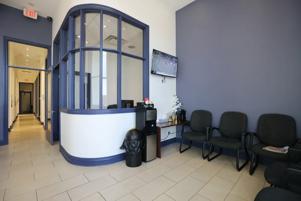 The waiting area with seating near the front desk