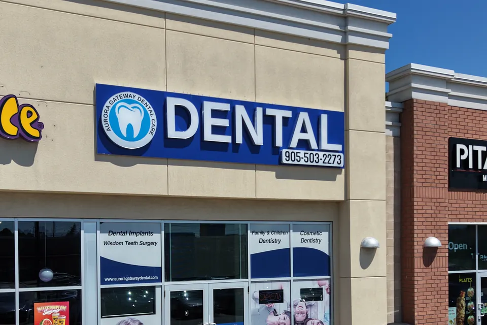 The clinic's blue DENTAL sign above the storefront