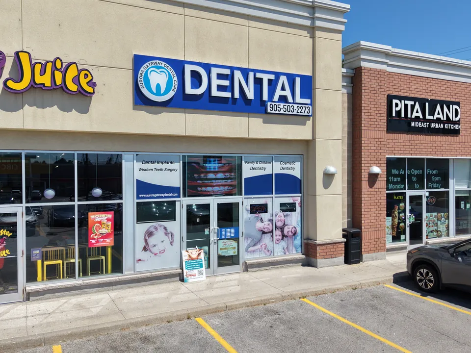 The plaza on Wellington Street East, with the blue DENTAL sign between the juice bar and Pita Land