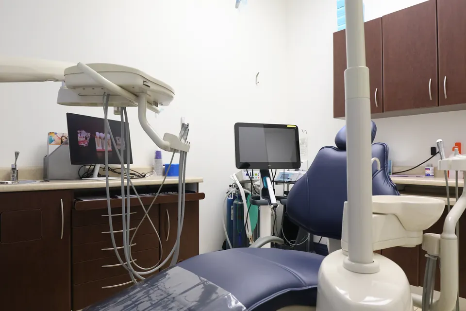A treatment room with a children's poster on the wall