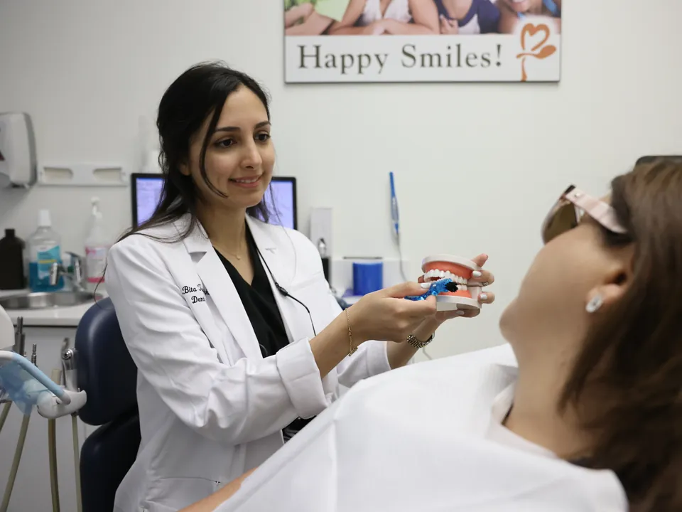 A dentist explains treatment options to a patient