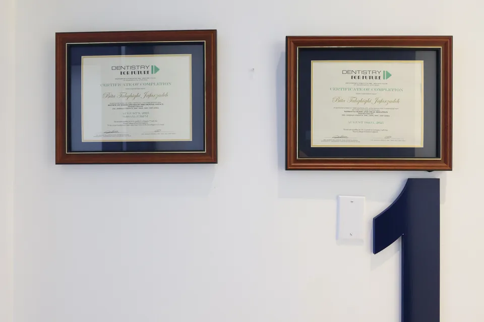 Framed certificates on the wall beside treatment room 1
