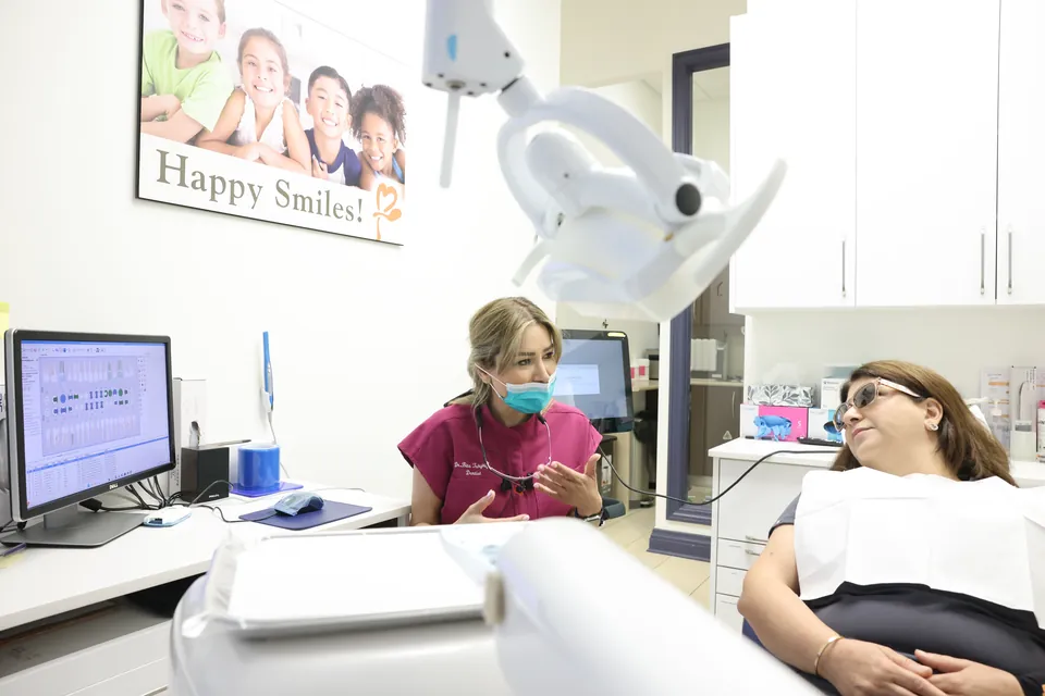 A team member chats with a patient before a checkup