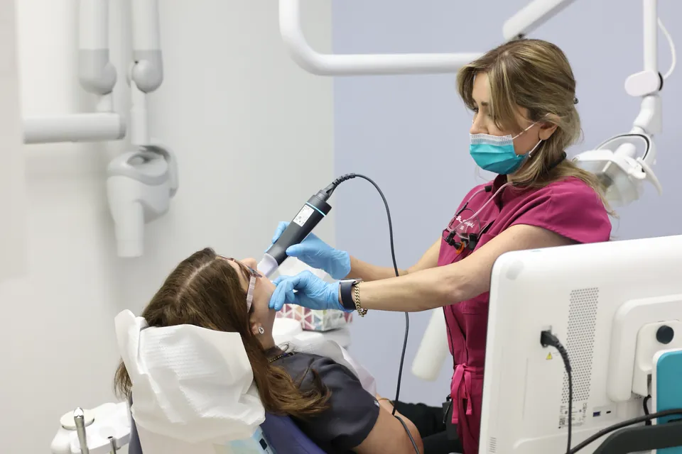 A team member works with a patient in a bright treatment room