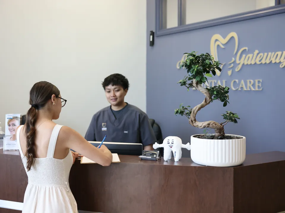 A new patient fills in forms at the front desk