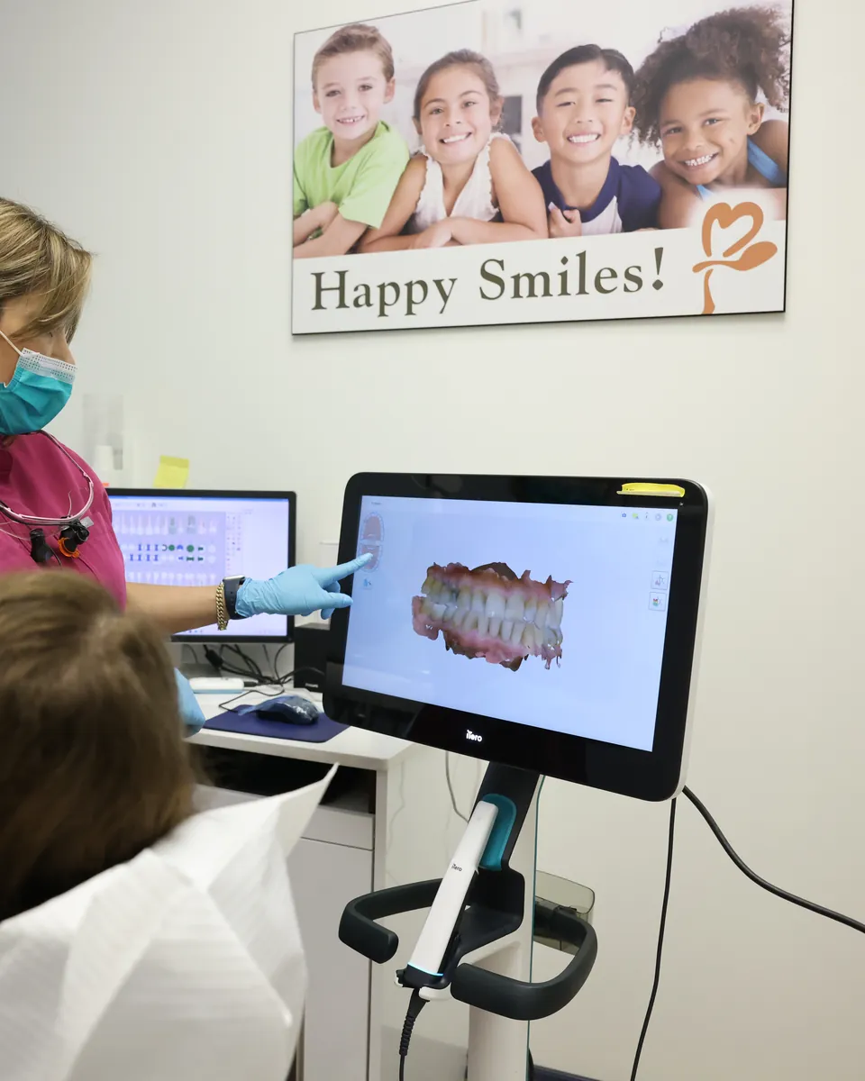 A team member reviews a 3D scan of a patient's teeth